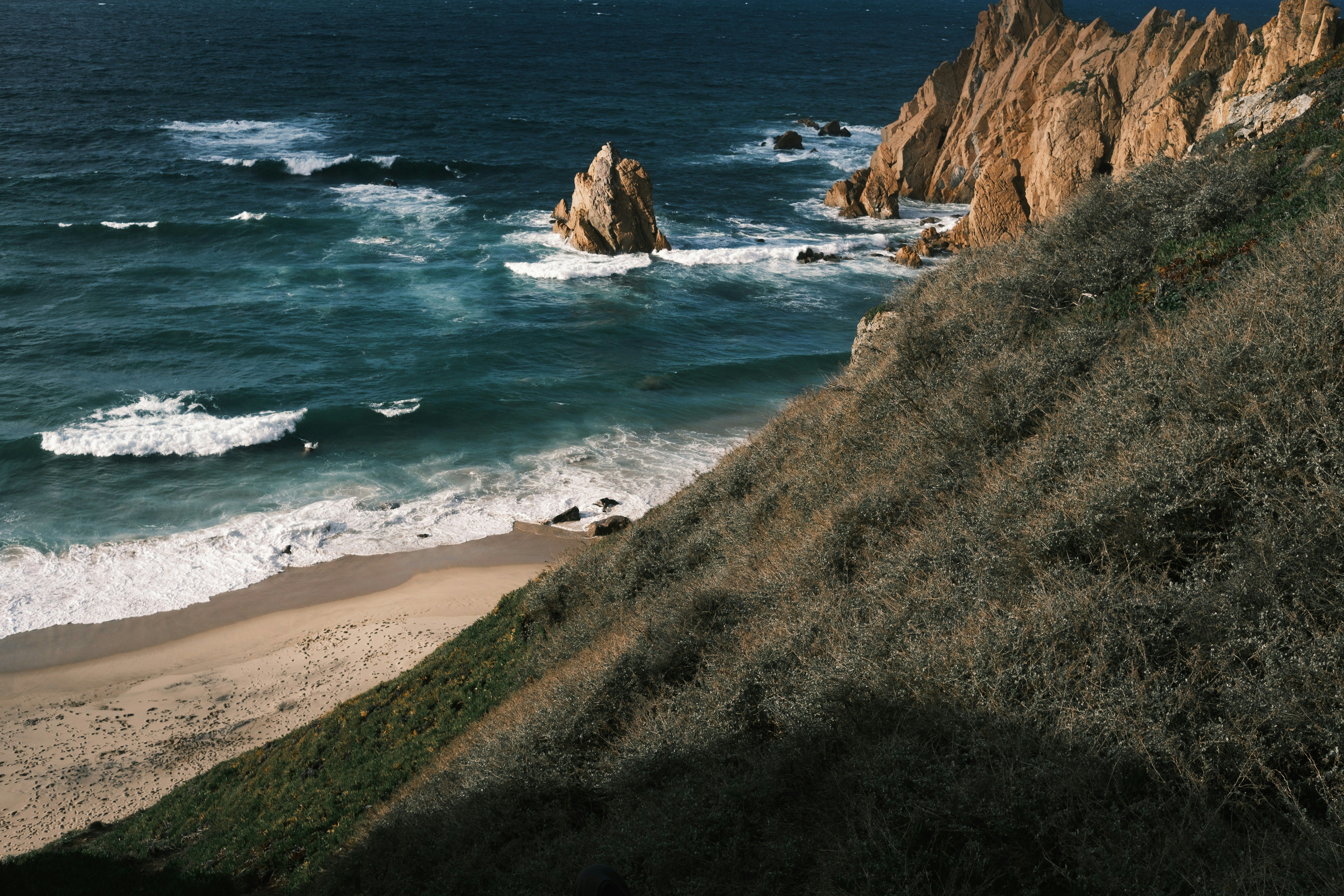 a view of the ocean from the top of a hill
